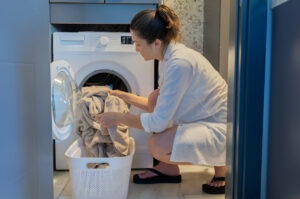An image showing silk and lace garments being gently hand-washed in a basin with cold water.